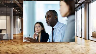 Serious businessman talking in meeting Wall mural