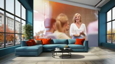 Smiling businesswoman leading meeting in conference room Wall mural