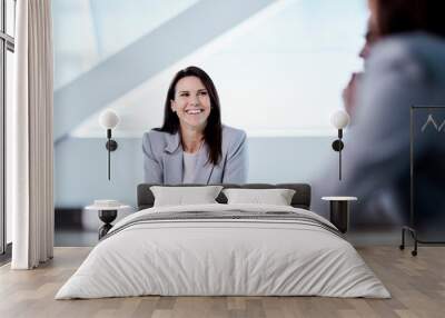 Smiling businesswoman listening in meeting Wall mural