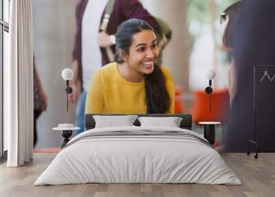 Smiling female college students with coffee and laptop Wall mural