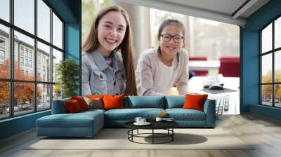 Student girls using computer in library Wall mural