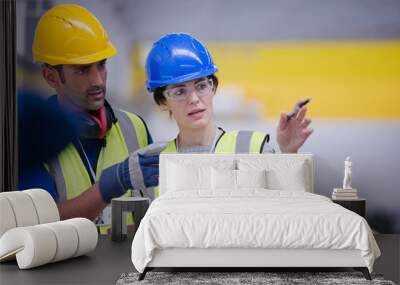 Supervisor and worker talking in factory Wall mural