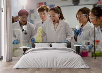 Surprised students conducting exploding foam scientific experiment in classroom laboratory Wall mural