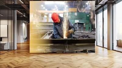 Welder using welding torch in steel factory Wall mural