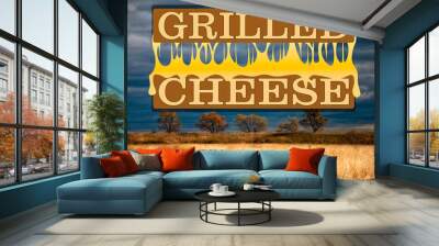 grilled cheese with melted cheese between pieces of bread logo against the background of cereals and a dark sky Wall mural