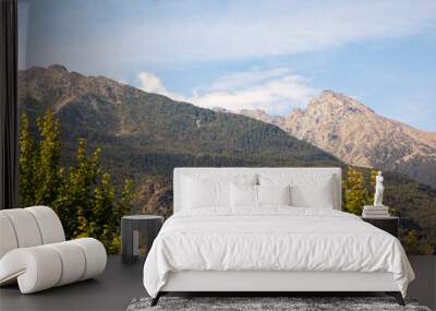 Landscape of mountains under a blue cloudy sky Wall mural