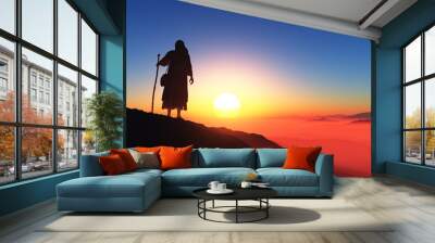 Traveler on a background of mountains. Wall mural