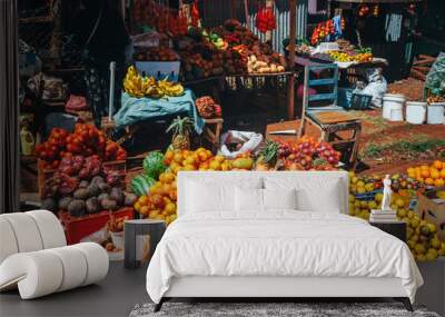 Fruit and vegetable market in Africa. Colorful healthy ingredients from the farm or from nature at the local market in Kenya. Bananas, mangoes, fruits and vegetables. Wall mural