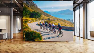 Sporty friends on bicycle on sunset light in beautiful nature by the sea. Road cycling on the coast. Sport in Nature background. Teamwork concept photo Wall mural