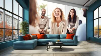 A group of people are sitting in chairs and one woman is smiling Wall mural