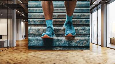 A man wearing blue shoes and socks is standing on a set of stairs Wall mural