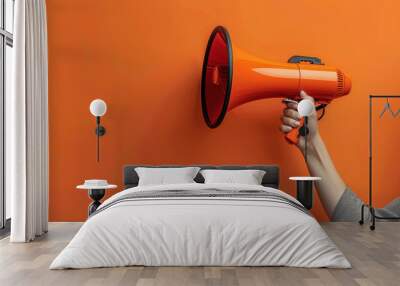 A person is holding a large orange microphone Wall mural