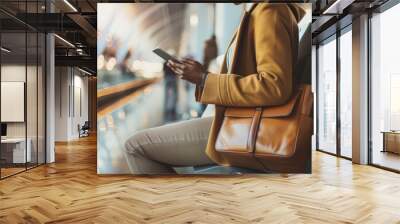 A woman is sitting on a bench with a brown purse and a tablet in her hand. She is looking at the tablet, possibly checking her email or browsing the internet. The scene is set in an airport Wall mural