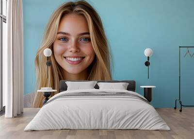 A woman with long blonde hair is smiling at the camera Wall mural