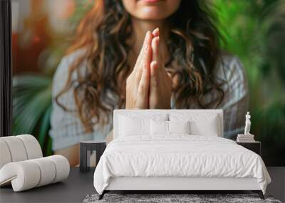 Close-up of Young Woman's Hands in Prayer Gesture with Serene Expression Wall mural