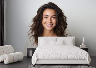 Portrait of a cheerful young woman wearing white shirt standing isolated over yellow background, looking at camera, posing Wall mural