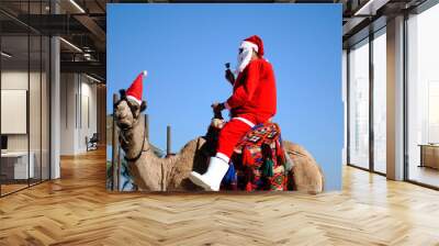 Santa Claus on a camel in the sky Wall mural