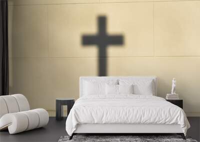 The shadow of the Christian cross on the wall. Selective focus. Wall mural