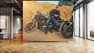 Smiling happy biker in sitting unknown on big chopper bike on road Wall mural