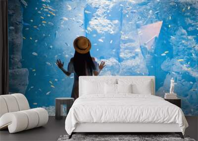 woman near big aquarium with fishes Wall mural