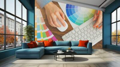 Young cute Graphic designer using graphics tablet to do his work at desk view from above Wall mural