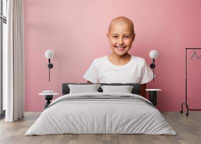 young little girl with cancer without hair smiling on pink background. Cancer day concept Wall mural