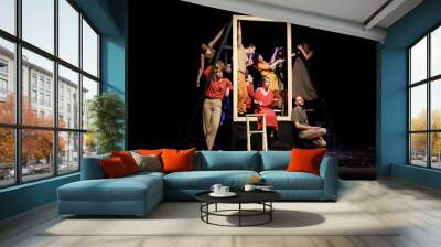 Actors and actresses perform a modern performance on the stage of the theater. Wall mural