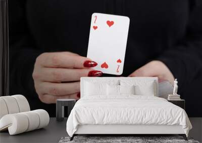 Female hands hold a deck of cards and show tricks.
The photographer is the author of the design of playing cards, which is written in the release of the property. Wall mural