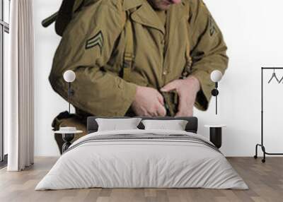 The man is an actor in the military uniform of an American ranger, wearing a helmet and with a carbine in his hands, the period of the Second World War is posing on a white background Wall mural