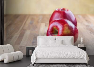 two ripe juicy apples lying on an oak table Wall mural