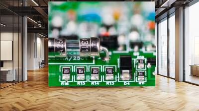 Electrical glass fuse or resistors, diode and transistor on printed circuit board in artistic detail. Small safety device soldered to green PCB and electronic components with surface mount technology. Wall mural