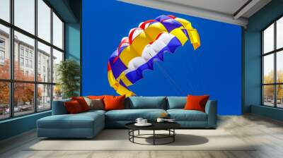 the colorful parachute in the blue sky Wall mural