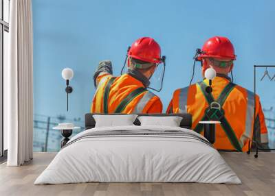 Two workers linemen look on power lines Wall mural