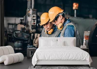 Engineer worker working on electronic a workshop. Engineer looking of working at industrial machinery setup in factory. Wall mural