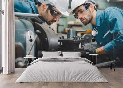 Two maintenance engineers discuss inspect relay checking machinery and repair system in a factory. They work a heavy industry manufacturing factory. Wall mural