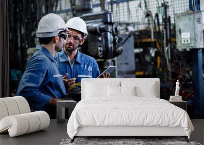 Two men engineer talking in modern factory. Production line machine and setting it for work. Wall mural