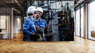 Two men engineer talking in modern factory. Production line machine and setting it for work. Wall mural