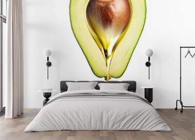 Drop of oily liquid flowing from a half of avocado on a white background Wall mural