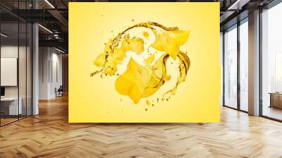 Sliced carambola with splashes of juice close-up on a yellow background Wall mural