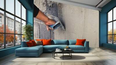 Concrete plasterers to create industrial workers background walls with plastering tools. Wall mural