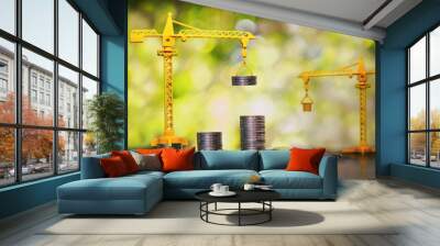 Construction cranes are stacking coins. business investment ideas Wall mural