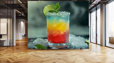 colorful cocktail served in a glass filled with crushed ice, garnished with a lime wedge and mint Wall mural