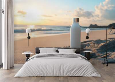 water bottle mockup featuring the white bottle on a sandy surface with a beach in the background Wall mural