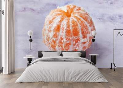  Single peeled tangerine at marble surface Wall mural