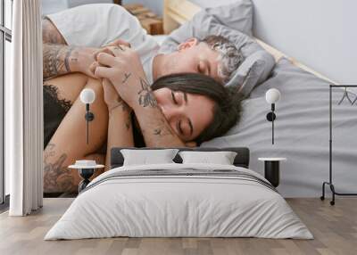 A tattooed couple embraces lovingly in a cozy bedroom, exemplifying intimate moments of a beautiful relationship. Wall mural