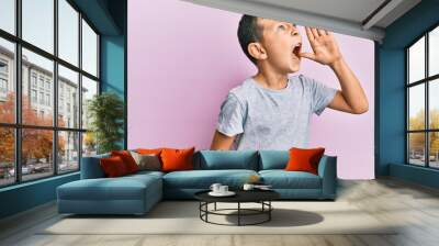 Adorable caucasian kid wearing casual clothes shouting and screaming loud to side with hand on mouth. communication concept. Wall mural