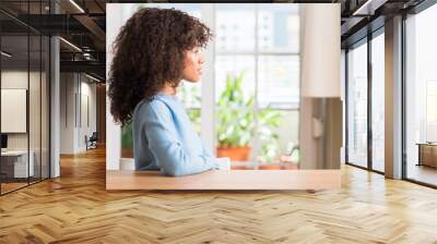 african american woman at home looking to side, relax profile pose with natural face with confident  Wall mural