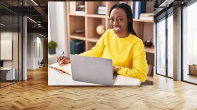 African american woman sitting on table studying at home Wall mural