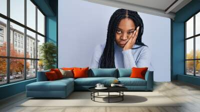 African american woman standing over blue background thinking looking tired and bored with depression problems with crossed arms. Wall mural