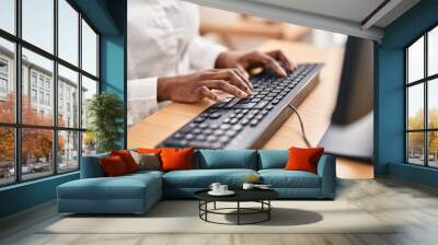 African american woman using computer keyboard at office Wall mural